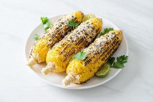 barbecue and grilled corn with cheese and lime photo