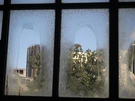 tarnished window glass view from electric plant industrial area photo