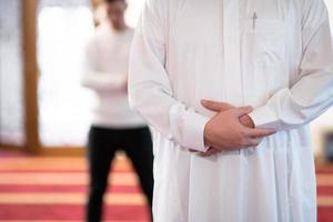 group of muslim people praying namaz in mosque. photo