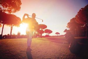 golf player hitting shot with club photo