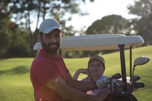 couple in buggy on golf course photo