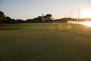 golf ball on edge of  the hole photo