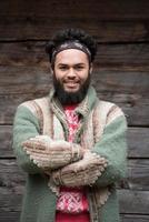 portrait of young hipster in front of wooden house photo