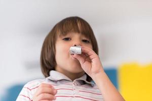 kid blowing a noisemaker photo