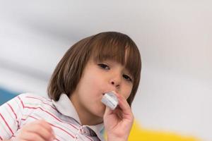 kid blowing a noisemaker photo