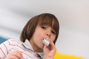 kid blowing a noisemaker photo