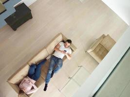 couple on sofa using mobile phones top view photo