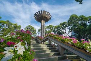 Wide angle view of Lotus pillar - An iconic architecture at Turtle lake , Ho Con Rua with blue sky in Saigon. photo