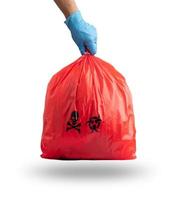 Hand holding Red garbage bag for infectious waste isolated on white background. clipping path photo