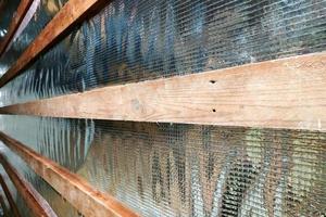 Insulation of the roof of the house on the inside with the use of a wrapper film and fixing boards photo