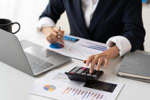 Business people discussing the charts and graphs showing the results of their successful teamwork, Financial inspector calculating a numbers in office room. photo