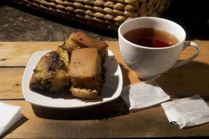 sweet cake and tea on wooden table photo