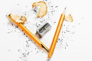 Pencil, metal sharpener and pencil shavings on white background. Horizontal image. photo