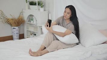 Woman using mobile phone to video call with girlfriend to communicate
