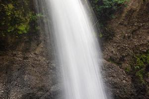 A natural waterfall in a big forest in the midst of beautiful nature. photo