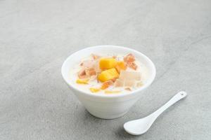 Mango Cheese Milk, a dessert made from jelly, nata de coco, basil seed, sweet mango, cream cheese and milk. photo