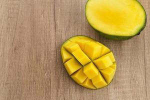 Fresh and ripe mango fruit on wooden table. Space for text. Close up. photo