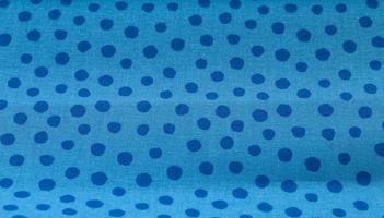 Close up view on samples of cloth and fabrics in different colors found at a fabrics market photo