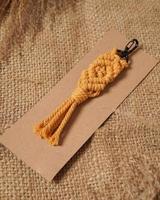 Macrame keychain, Macrame shot, handmade by women at home. Great DIY images for macrame and crafts banners and advertisements. creative hobby layout with accessories, top view. Handcrafted macrame. photo