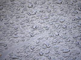 rain drops on blue metal close up macro photo