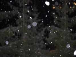 snowing at night in dolomites mountains photo