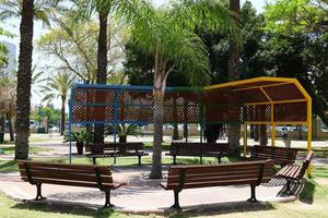 Nahariya Israel June 5, 2021 Bench in a city park on the Mediterranean coast photo