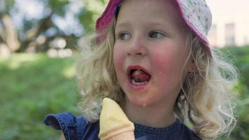 Little blonde girl eating ice cream video