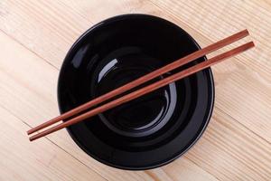 Chopsticks in asian set table on wood background photo