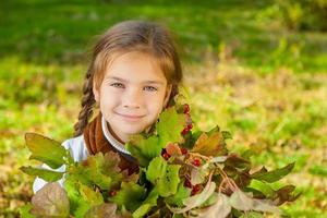 Little girl with red viburnum photo
