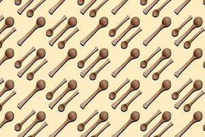 Wooden spoons, top view of wooden spoons isolated on yellow background. Kitchenware pattern background. photo