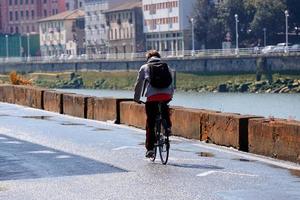 Bilbao, Vizcaya, Spain, 2022 - cyclist on the street, bicycle mode of transportation in the city photo