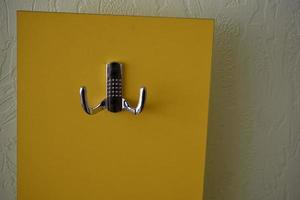 Yellow hanger indoors at home with silver handles photo