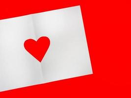 papel blanco perforado en forma de corazón. colocado sobre un fondo rojo foto