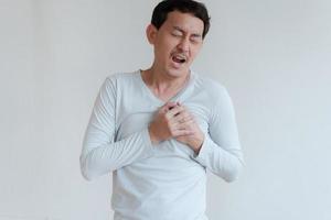 a man touching his heart, with red highlight of heart attack, and others heart disease concept, Heart attack symptom photo