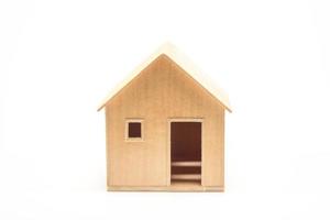 Toy wooden house model on white photo