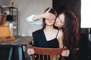 Girl holding hand and close eyes her girlfriend photo