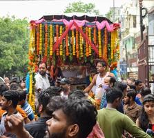 New Delhi, India July 01 2022 - A huge gathering of devotees from different parts of Delhi on the occasion of ratha yatra or rathyatra. Rath for Lord Jagannath pulled by people, Jagannath Rath Yatra photo