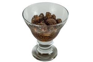 glass ramekin of jam made from pine cones on a white background photo