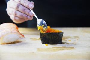 japanese maki sushi roll serving in oriental restaurant, chef is preparing japan tradition cookery menu, various different assorted luxury mixed healthy eating set concept photo