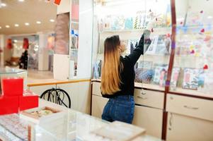 retrato de una joven vendedora caucásica. pequeña empresa de tienda de souvenirs de dulces. foto