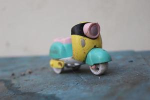 photo macro of a used toy car that is damaged, dirty and unused