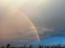 rainbow over the field after rain photo