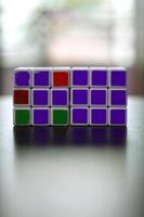 Rubik's cube on the black background. Rubik's Cube was invented by Hungarian architect Erno Rubik in 1974. photo