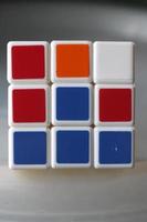 Rubik's cube on the black background. Rubik's Cube was invented by Hungarian architect Erno Rubik in 1974. photo