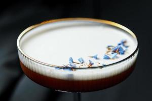 Alcoholic drink. A cocktail with elite alcohol on dark black background, close-up. photo