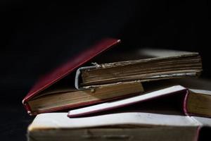 a collection of old books that are weathered in piles. vintage and retro theme backgrounds photo