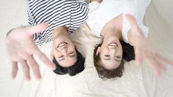 Top view of young asian couple on the bed in bedroom, happy family concept photo