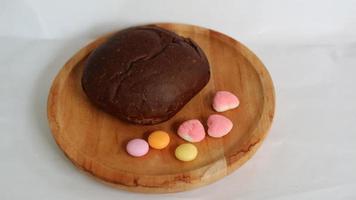 Dark brown bread and six cute candies photo