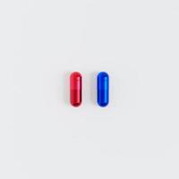 Blue and red capsule pills on white background, healthcare medical concept, antibiotics and cure, 3d render photo