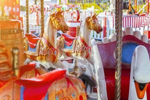 Vintage Merry-Go-Round flying horse carousel in amusement holliday park photo